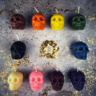 Small beeswax skull spell candle from Parlour of Wonders with orange wax, designed for mind influence and ancestral wisdom magic.