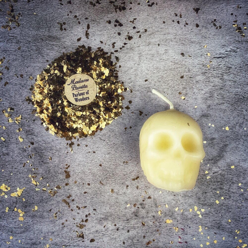 Beeswax small skull spell candle by Parlour of Wonders with orange wax, designed for mind influence and ancestral wisdom magic.