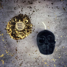 Beeswax small skull spell candle with orange wax, featuring intricate designs for mind influence and ancestral wisdom magic.