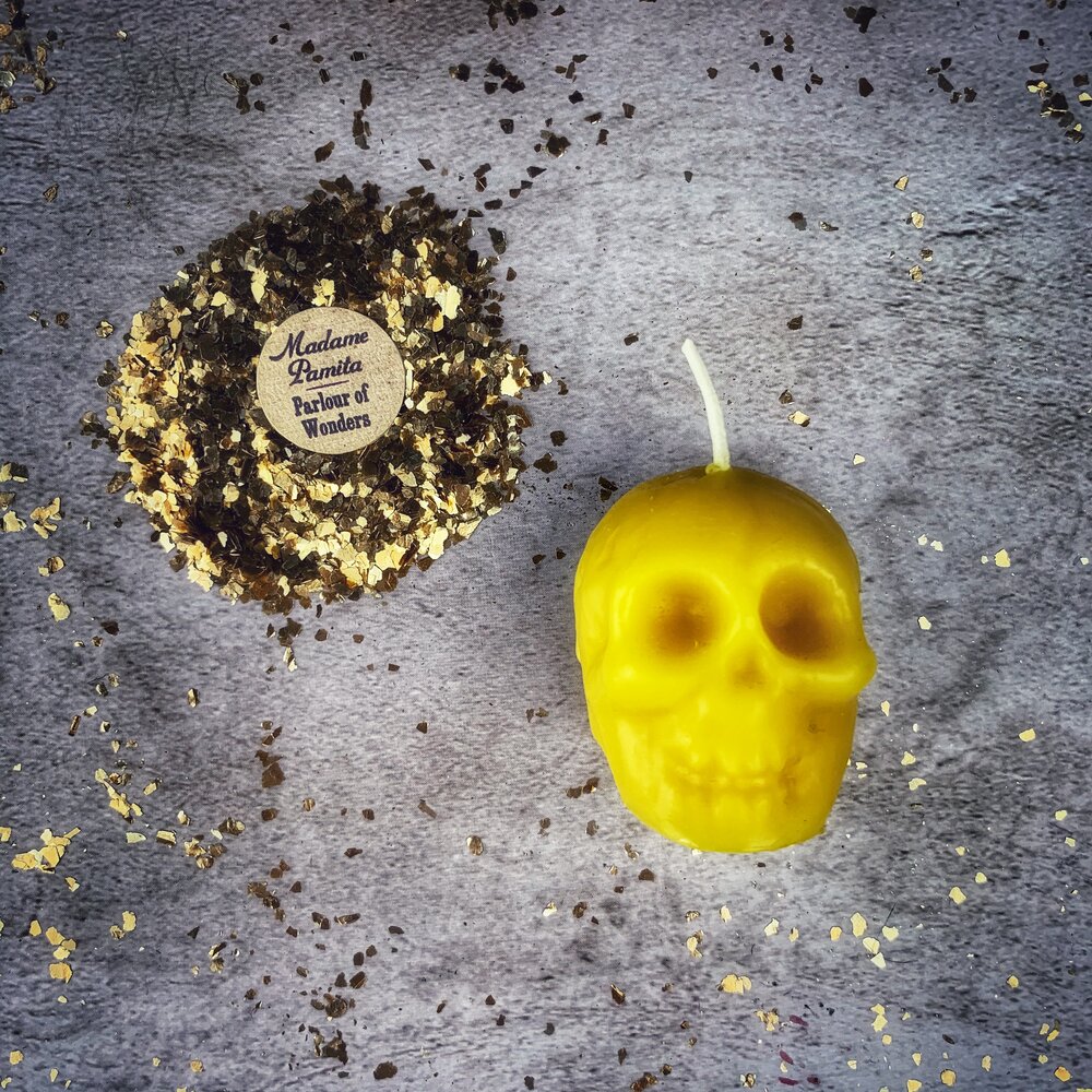 Small beeswax skull spell candle from Parlour of Wonders, orange color, designed for mind influence and ancestral wisdom magic.