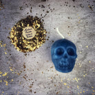 Small beeswax skull spell candle by Parlour of Wonders with orange wax, designed for mind influence and ancestral wisdom magic.