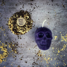 Small beeswax skull candle with orange accents, designed for mind influence and ancestral wisdom magic by Parlour of Wonders.