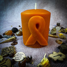 Beeswax pillar candle with awareness ribbon design by Parlour of Wonders, honoring heroes and supporting causes.