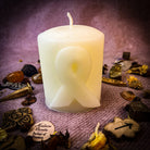 Beeswax awareness ribbon pillar spell candle by Parlour of Wonders for honoring heroes and supporting causes, with a natural beeswax finish.