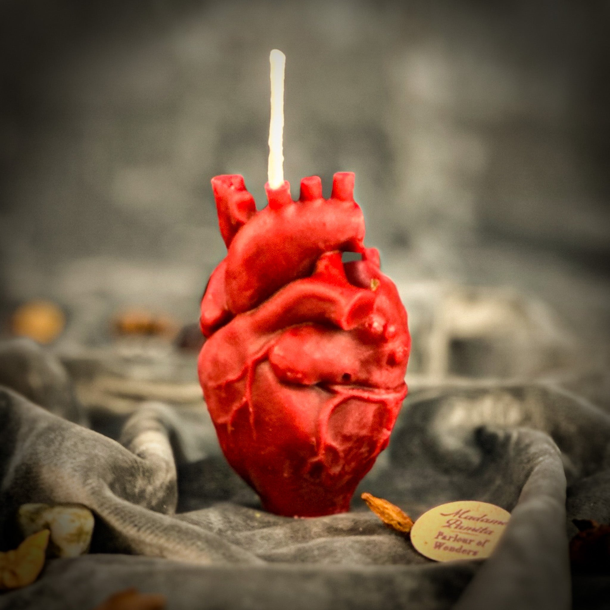 Pink beeswax candle shaped like an anatomical heart for love and emotional healing, from Parlour of Wonders.
