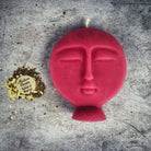 Pink beeswax candle with ancestral symbols, used for guidance and protection in magic rituals by Parlour of Wonders.