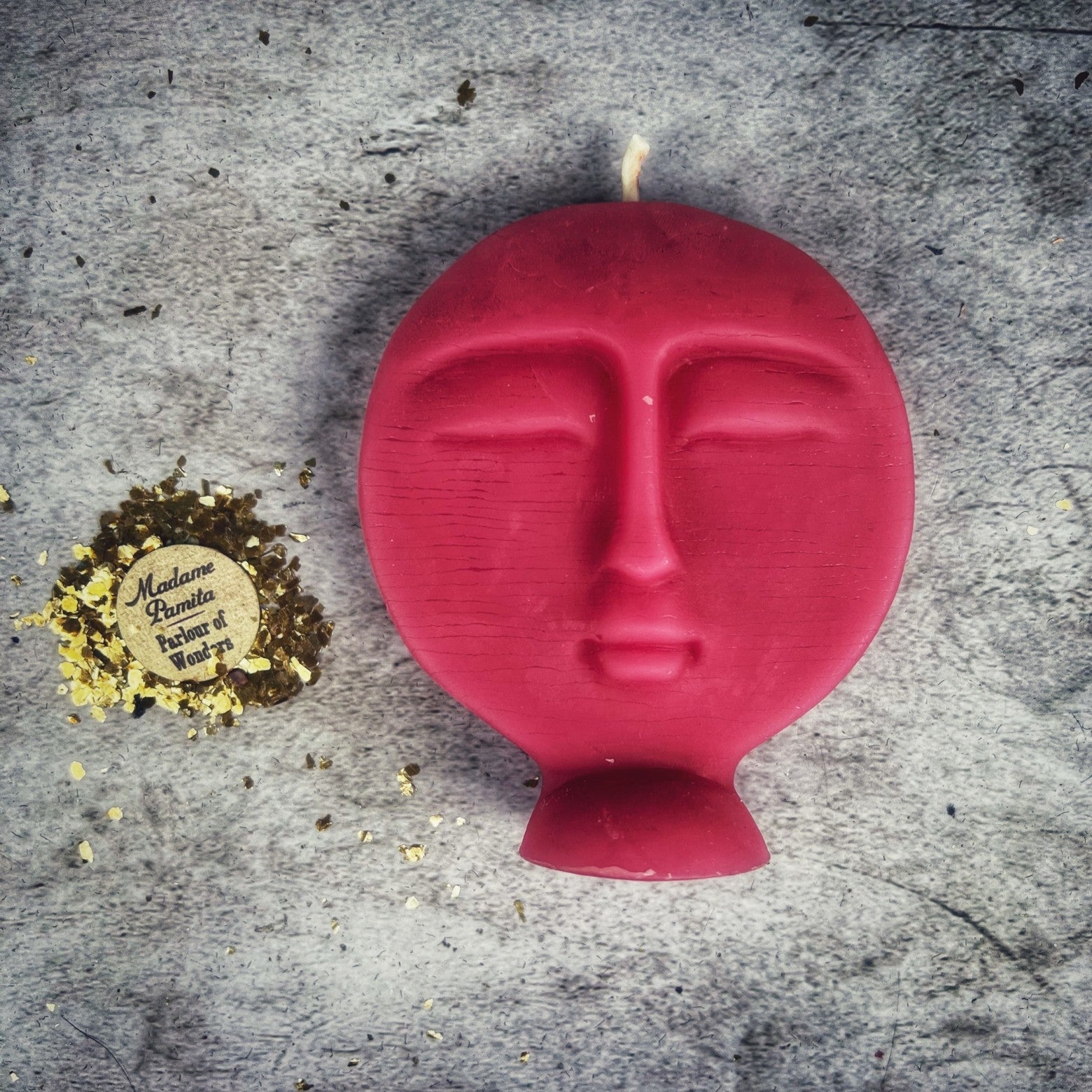 Pink beeswax candle with ancestral symbols, used for guidance and protection in magic rituals by Parlour of Wonders.