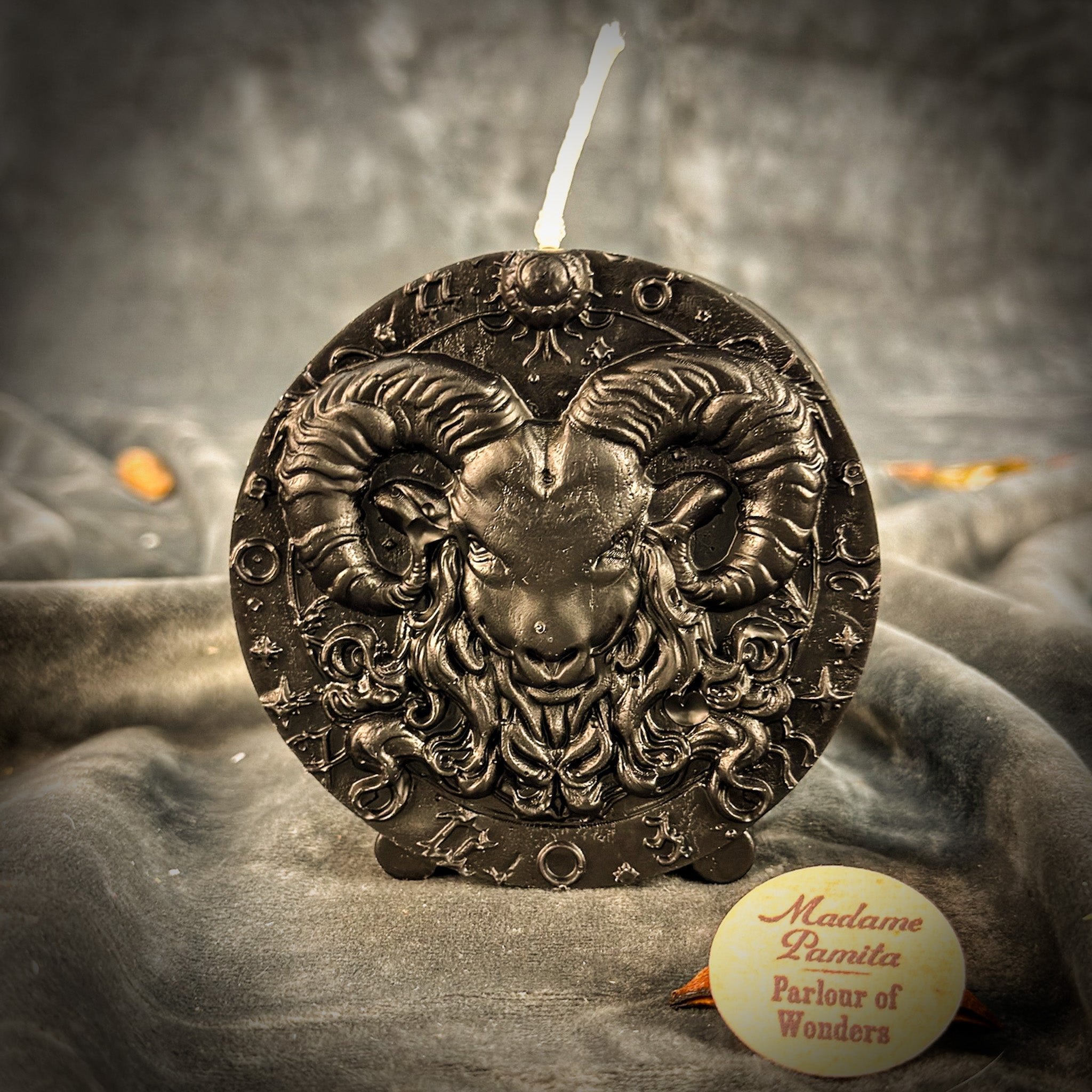 Pink beeswax Aries Ram zodiac spell candle with flame, symbolizing courage, passion, and victory, by Parlour of Wonders