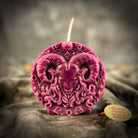 Pink beeswax Aries Ram zodiac spell candle with zodiac symbols, representing courage, passion, and victory.