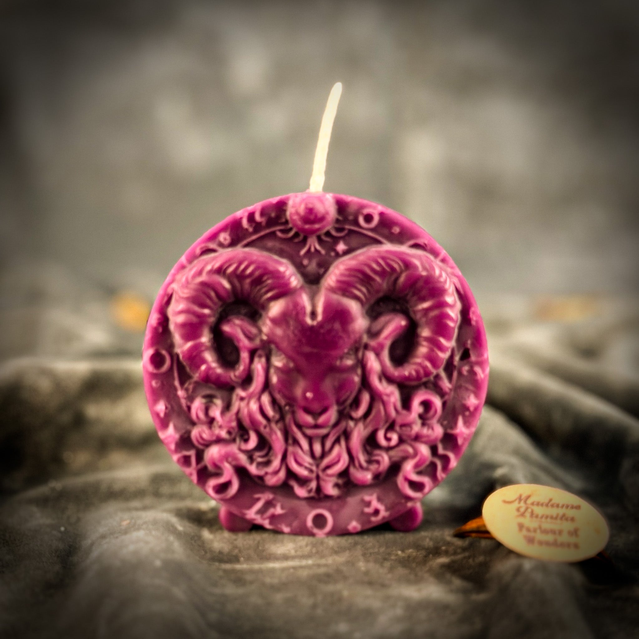 Pink beeswax Aries Ram zodiac spell candle with zodiac symbols, representing courage, passion, and victory.