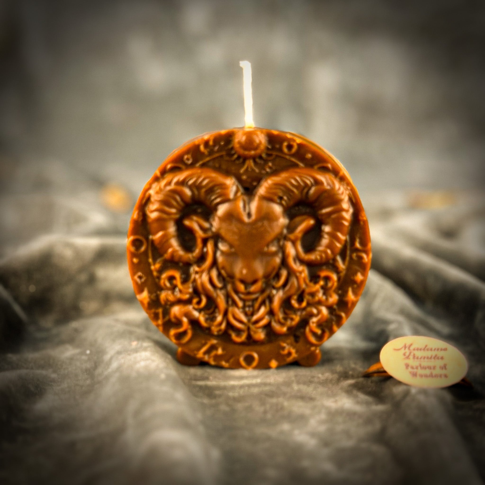 Pink beeswax Aries Ram zodiac spell candle by Parlour of Wonders, featuring detailed ram design for courage, passion, and victory.