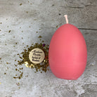 Pink beeswax egg talisman spell candle by Parlour of Wonders, representing new beginnings and fertility magic.