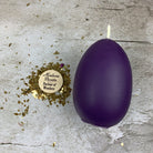 Pink beeswax egg talisman candle by Parlour of Wonders for new beginnings and fertility magic, with intricate design and natural wax texture.
