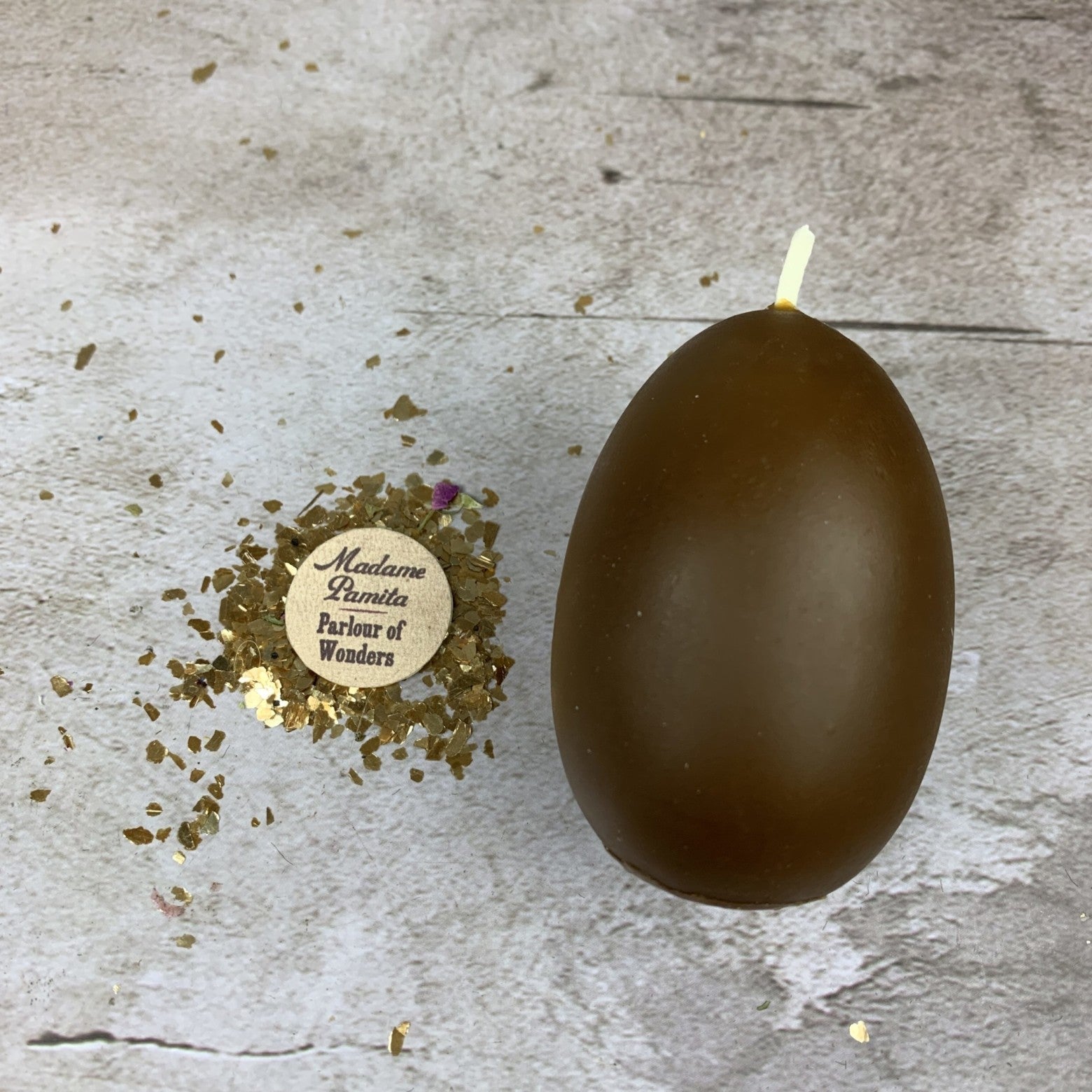 Pink beeswax egg talisman spell candle by Parlour of Wonders, symbolizing new beginnings and fertility magic.