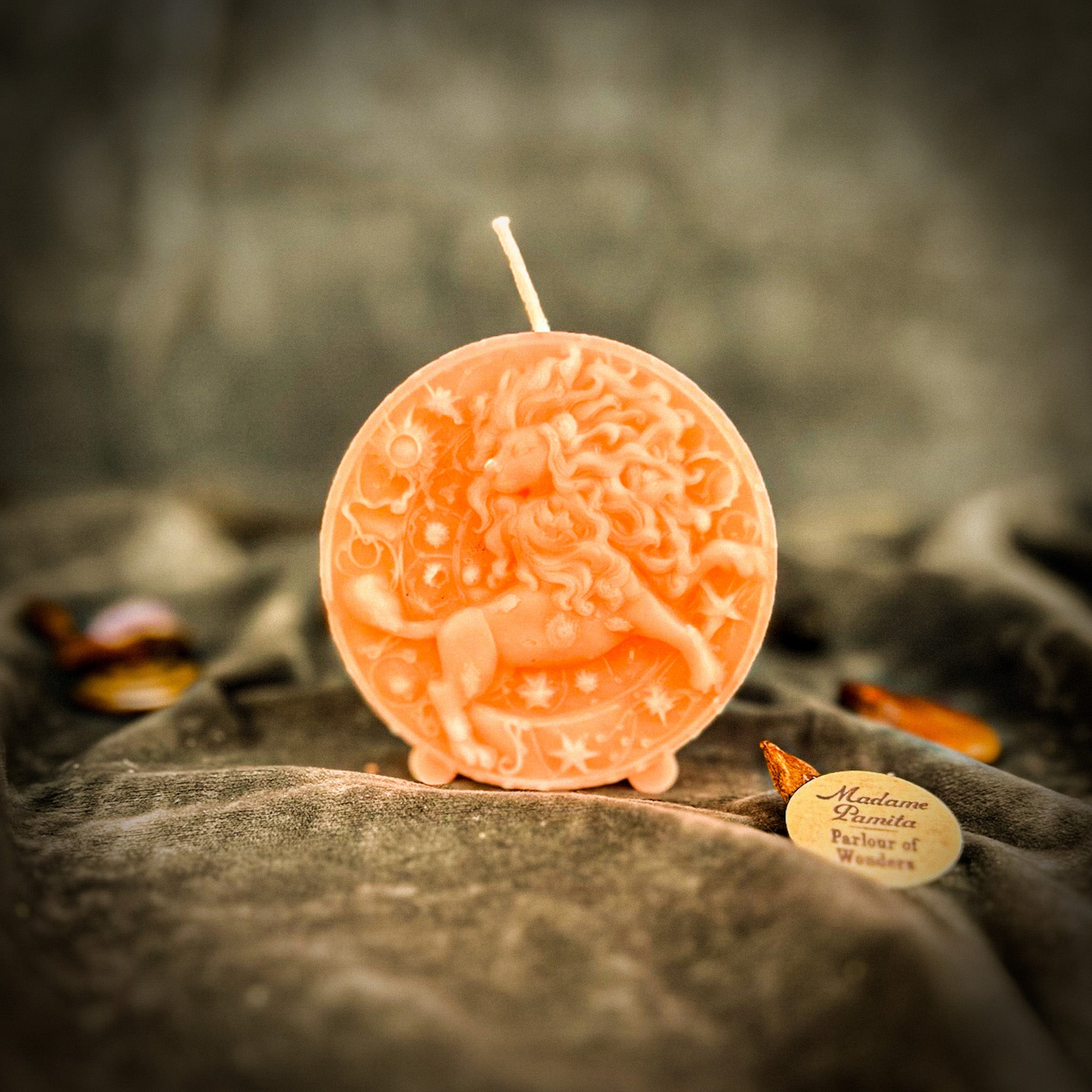 Pink beeswax Leo Lion zodiac spell candle by Parlour of Wonders, featuring intricate lion design for creativity and confidence.