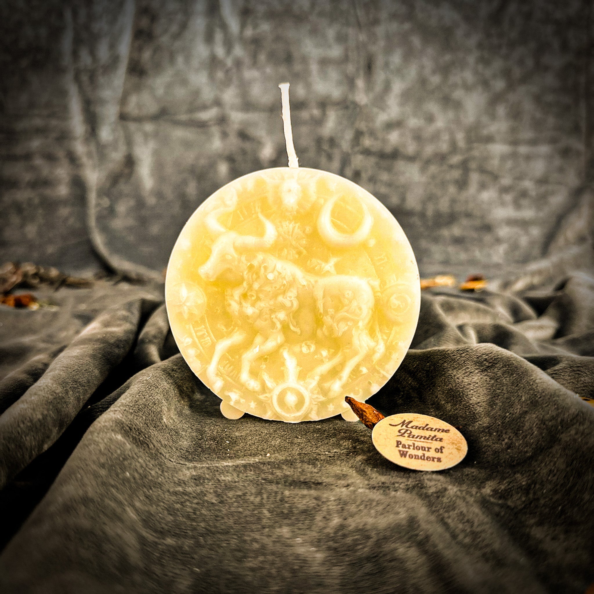 Pink beeswax Taurus Bull zodiac spell candle by Parlour of Wonders, symbolizing abundance, stability, and sensuality.