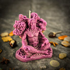Beeswax Horned God Spell Candle by Parlour of Wonders with Cernunnos design, purple wax, symbolizing nature magic and fertility.