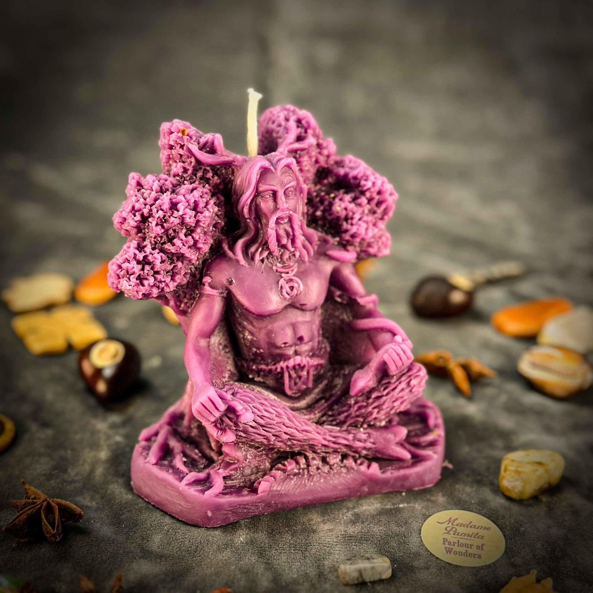 Beeswax Horned God Spell Candle by Parlour of Wonders with Cernunnos design, purple wax, symbolizing nature magic and fertility.