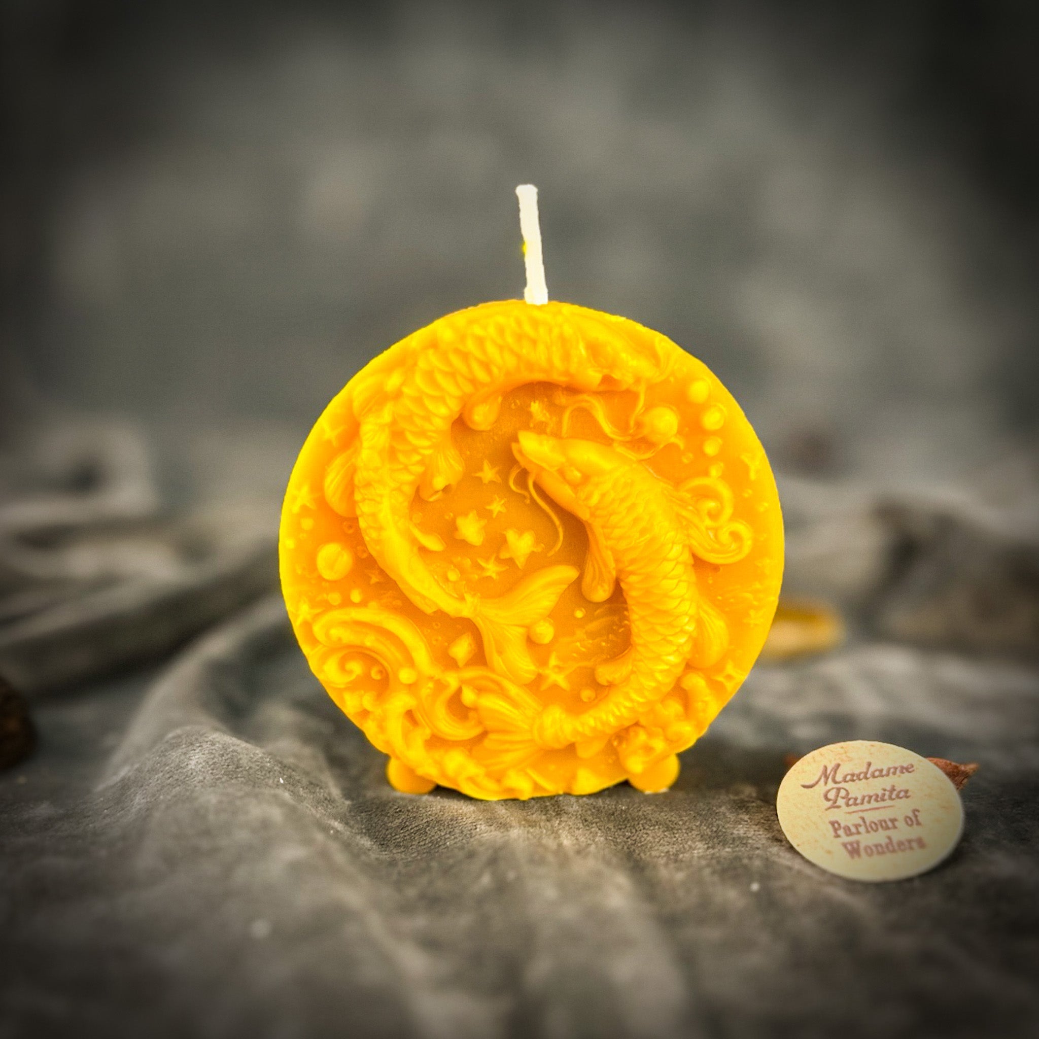Purple beeswax Pisces Fish zodiac spell candle by Parlour of Wonders with intricate fish design for intuition, compassion, and dreams.