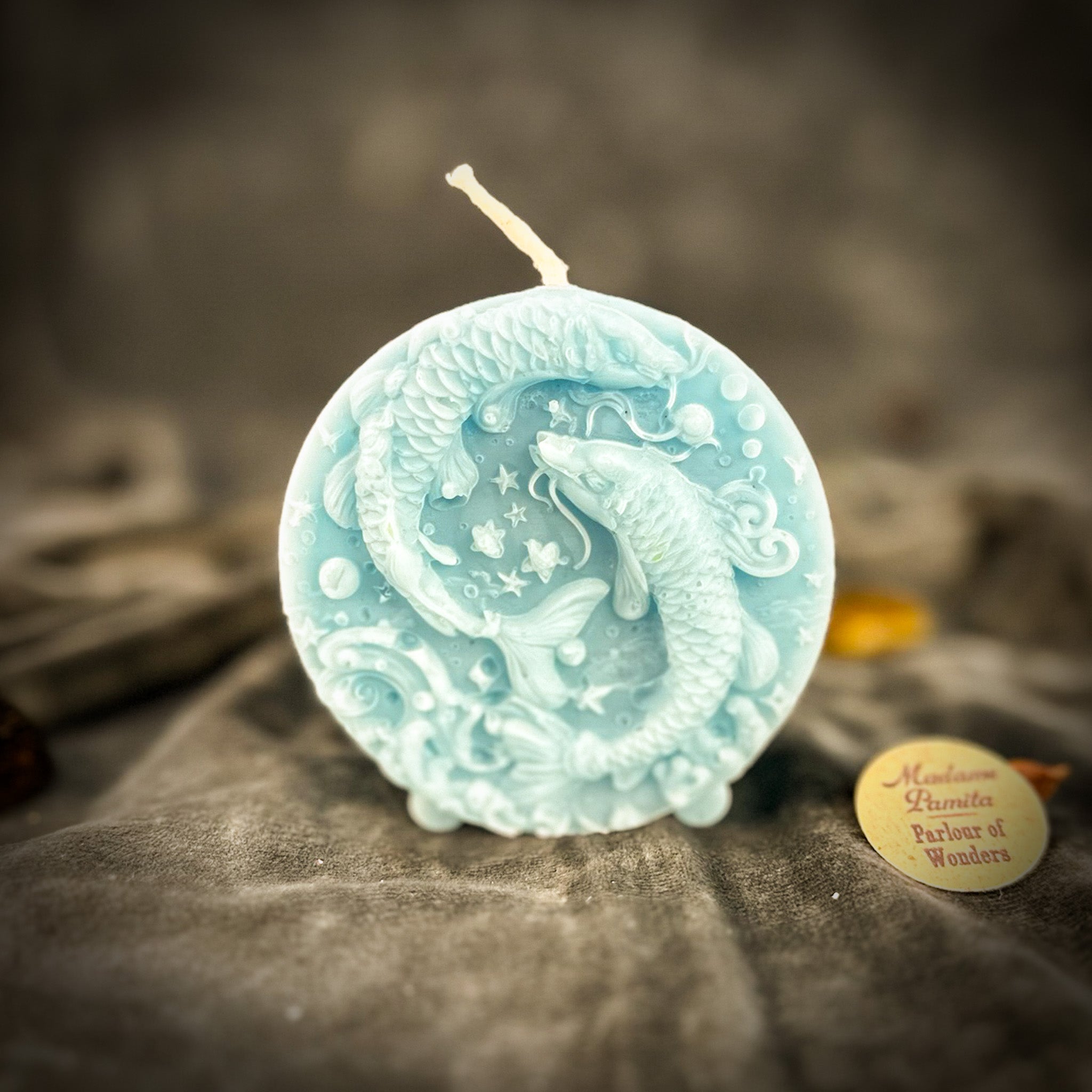 Purple beeswax Pisces fish zodiac spell candle by Parlour of Wonders, featuring intricate fish design for intuition, compassion, and dreams.