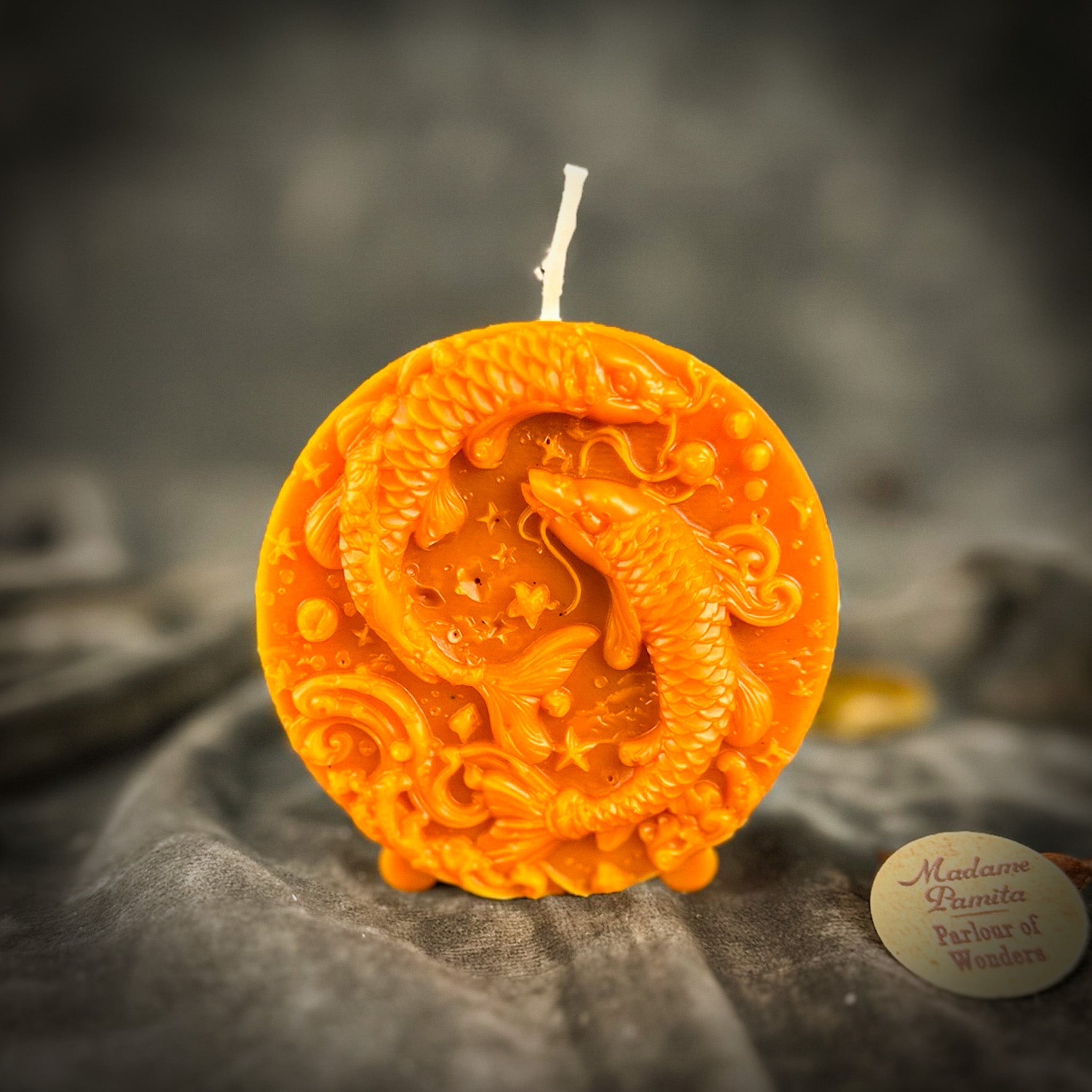 Purple beeswax Pisces fish zodiac spell candle by Parlour of Wonders, featuring intricate fish design symbolizing intuition and compassion.
