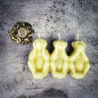 Red beeswax candle featuring three wise monkeys design for protection, silence, and banishing jealousy in spiritual rituals.