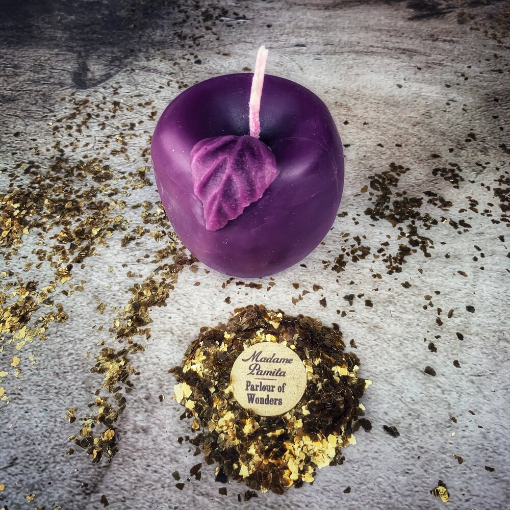 Red beeswax Apple of Avalon spell candle by Parlour of Wonders, featuring intricate details for love and abundance magic.