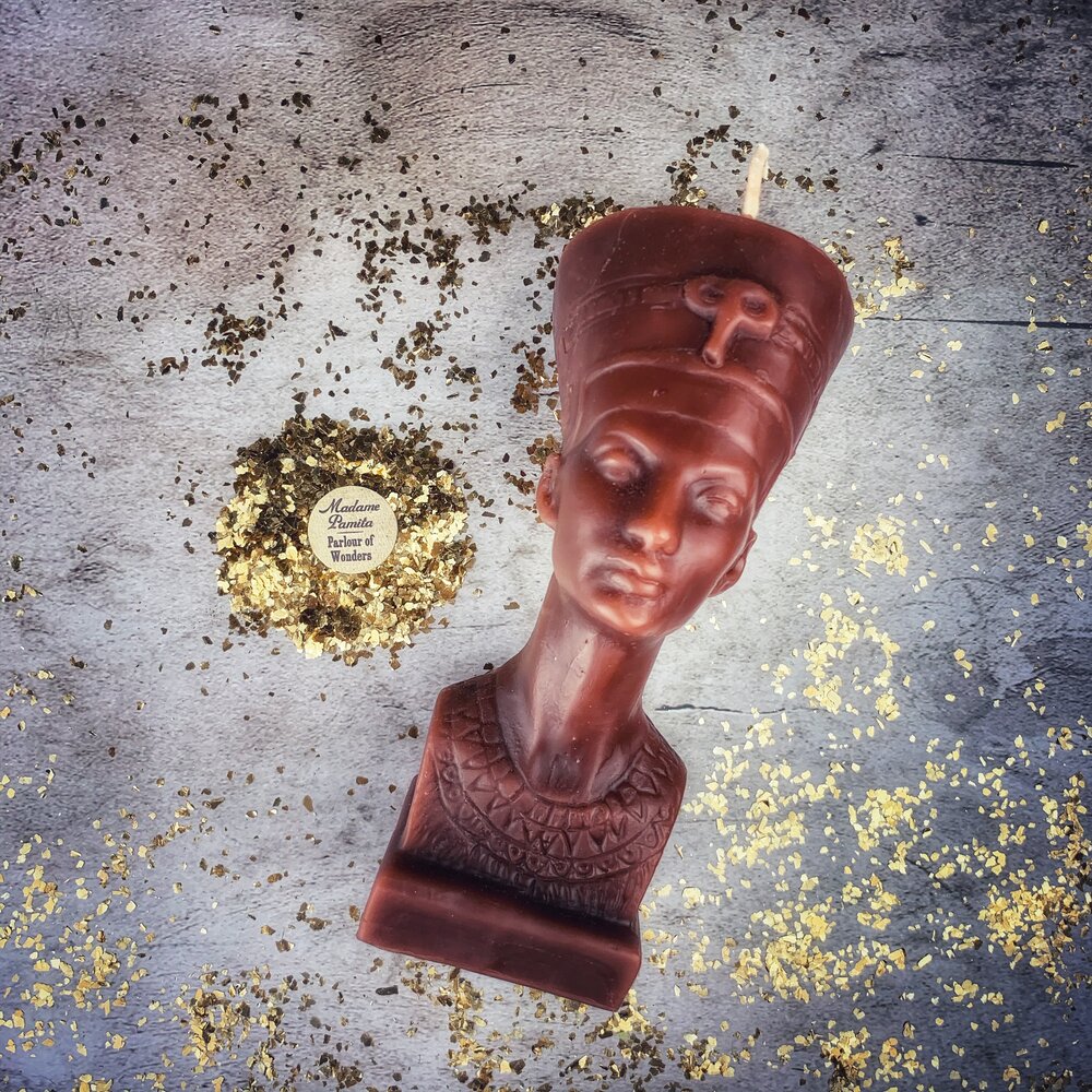 Red beeswax Egyptian Queen spell candle by Parlour of Wonders, featuring intricate design for power, beauty, and magnetism magic.
