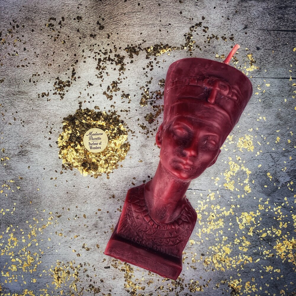Red beeswax Egyptian Queen spell candle by Parlour of Wonders, featuring intricate design symbolizing power, beauty, and magnetism magic.