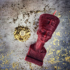 Red beeswax Egyptian Queen spell candle by Parlour of Wonders, featuring intricate design symbolizing power, beauty, and magnetism magic.
