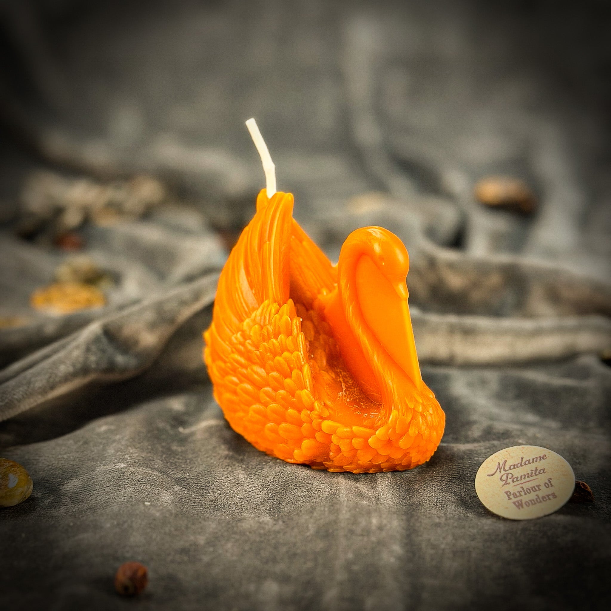 Red beeswax elegant swan spell candle from Parlour of Wonders, showcasing intricate design and warm, rich wax finish.
