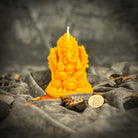 Red beeswax Ganesha spell candle from Parlour of Wonders with intricate carvings, used for obstacle removal and success magic.
