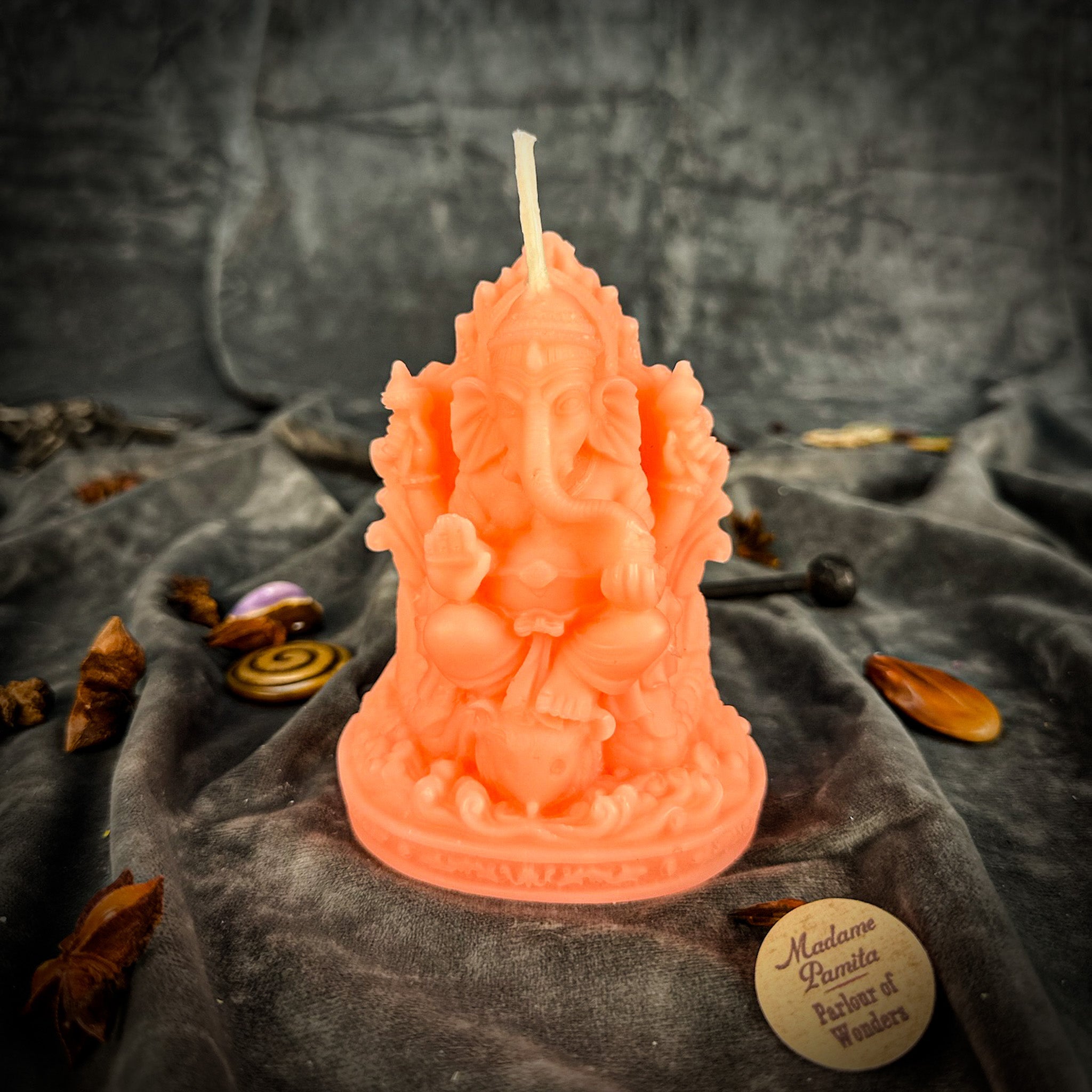 Red beeswax Ganesha spell candle from Parlour of Wonders, featuring intricate Ganesha design for obstacle removal and success magic.
