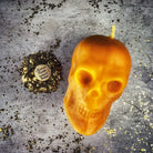 Large beeswax skull spell candle with red passion color, used for mind influence and ancestral wisdom magic, by Parlour of Wonders.