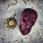 Large red beeswax skull candle from Parlour of Wonders with intricate details, ideal for mind influence and ancestral wisdom magic.