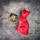 Red beeswax Lucky Cat spell candle by Parlour of Wonders, used for fast action and manifestation magic.
