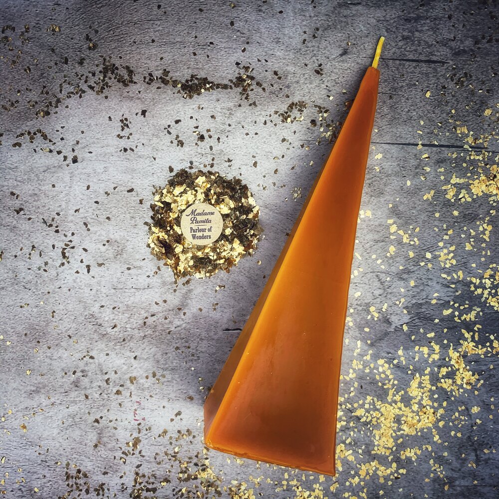 Red beeswax pyramid candle by Parlour of Wonders, used for success and stability magic, featuring a natural beeswax finish.