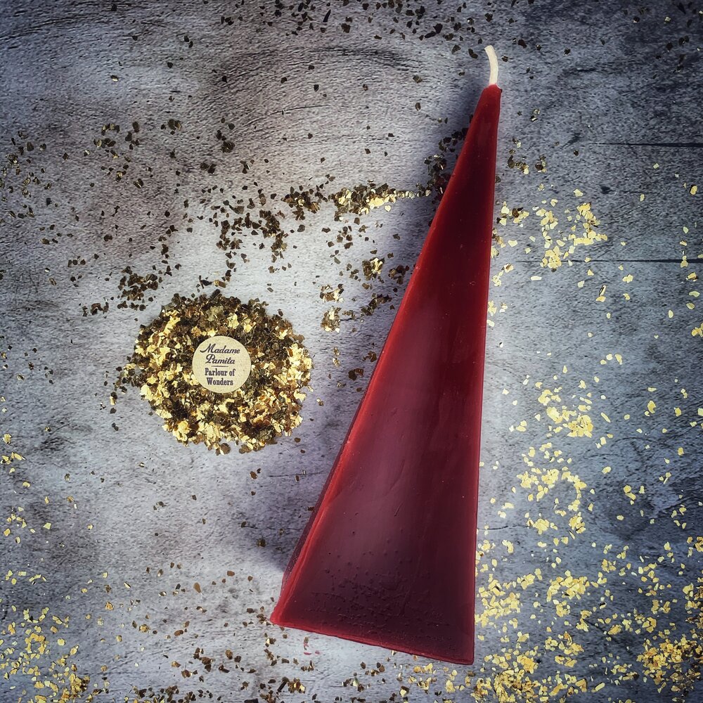 Red beeswax pyramid candle by Parlour of Wonders for success and stability magic, featuring a long-lasting beeswax spell design.