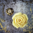 Red beeswax candle with rose design by Parlour of Wonders, used for love and soul mate magic rituals.
