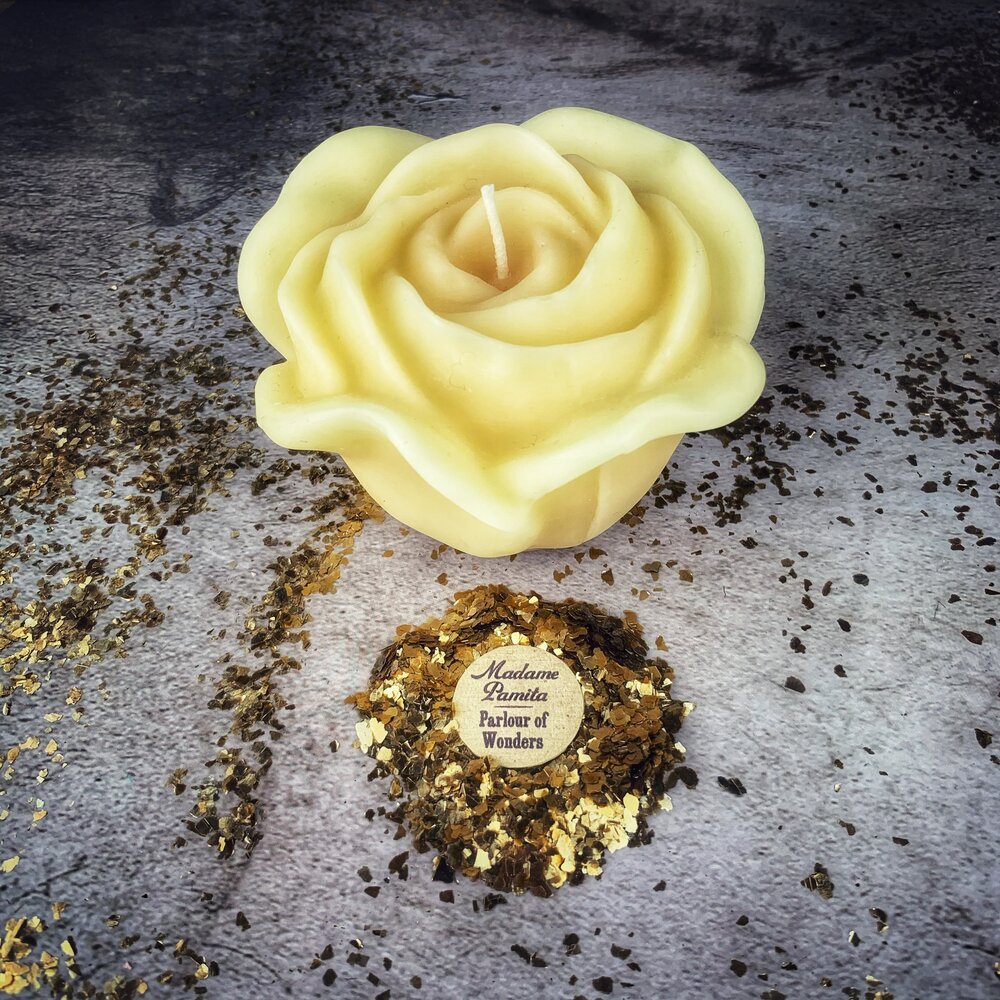 Red beeswax candle with rose design by Parlour of Wonders, used for love and soulmate magic, featuring intricate wax detailing.