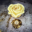 Red beeswax candle with rose design by Parlour of Wonders, used for love and soulmate magic, featuring intricate wax detailing.