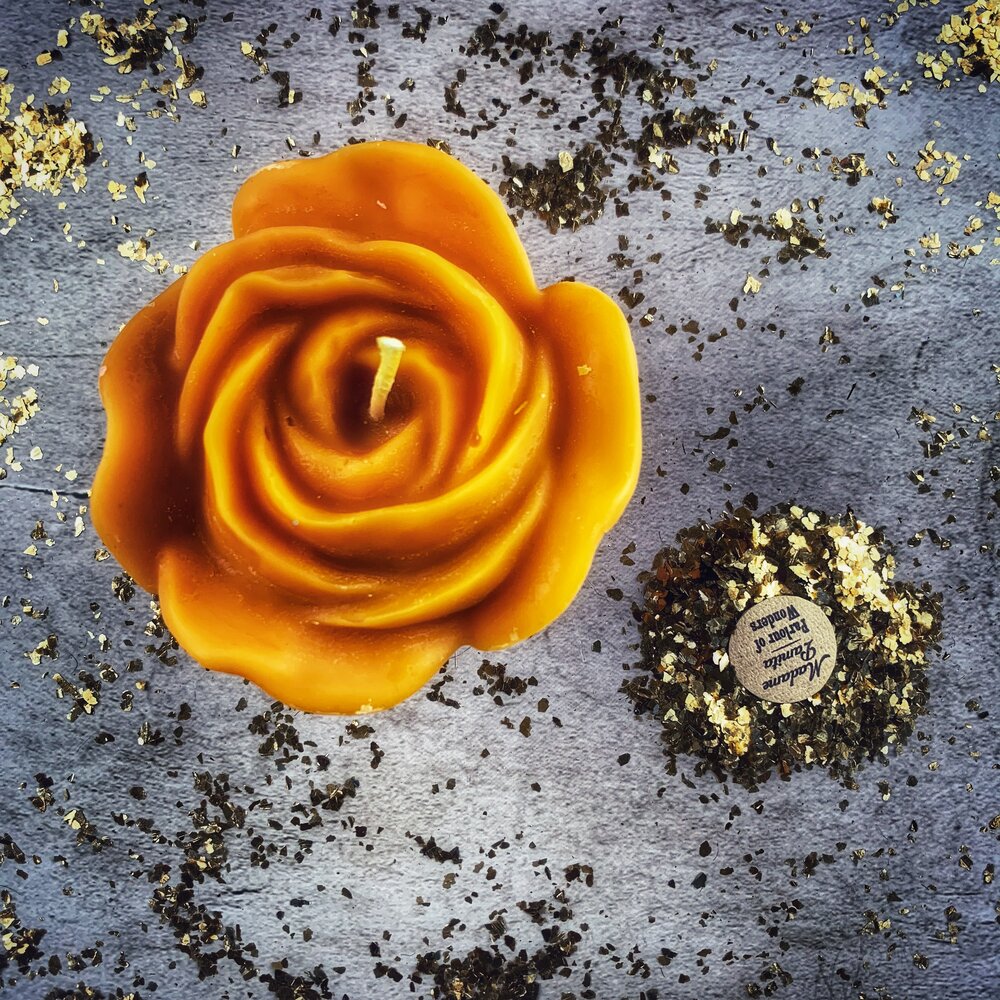 Red beeswax candle with rose design from Parlour of Wonders, used for love and soulmate magic rituals.