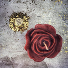 Red beeswax candle with rose design by Parlour of Wonders, used for love and soul mate magic spells.