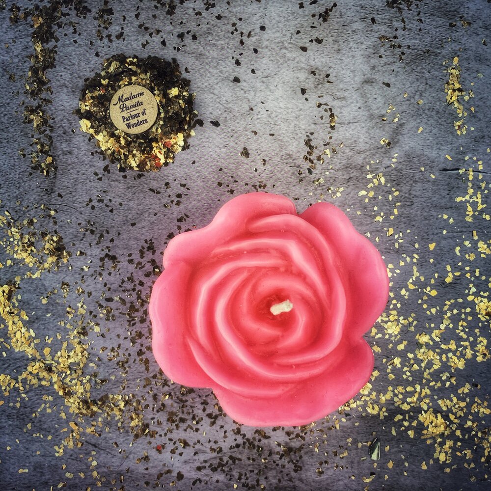 Red beeswax candle with rose design for love and soulmate magic, from Parlour of Wonders, showcasing its romantic and mystical appearance.