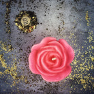 Red beeswax candle with rose design for love and soulmate magic, from Parlour of Wonders, showcasing its romantic and mystical appearance.