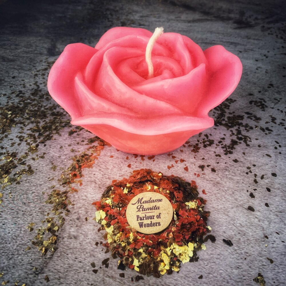 Red beeswax candle with rose design from Parlour of Wonders, used for love and soul mate magic spells.