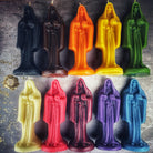 Red beeswax Santa Muerte spell candle with intricate sacred folk saint design for devotion and protection magic.