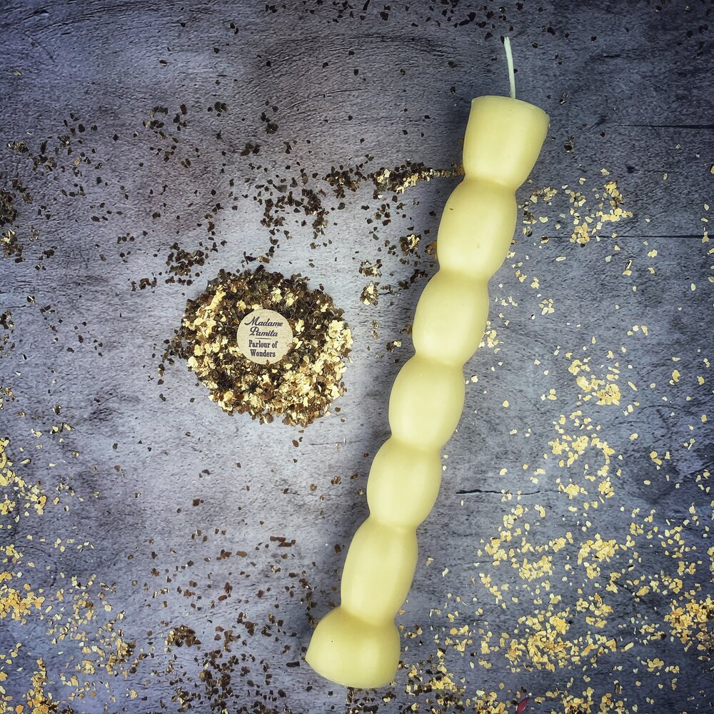 Red beeswax Seven Knob Spell Candle by Parlour of Wonders for seven-day manifestation magic, featuring multiple knobs and intricate design.