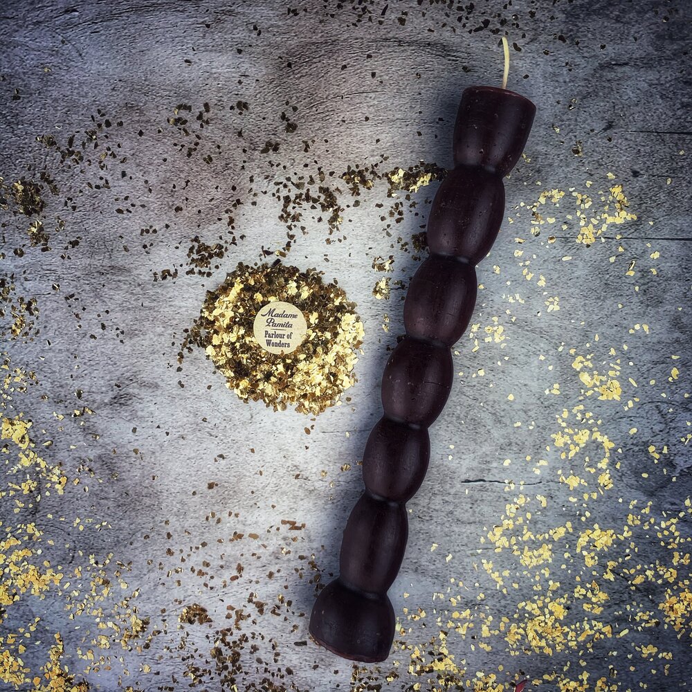 Red beeswax seven-knob spell candle from Parlour of Wonders for seven-day manifestation magic, featuring intricate wax details.