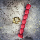 Red beeswax seven-knob spell candle by Parlour of Wonders for seven-day manifestation and magic rituals.